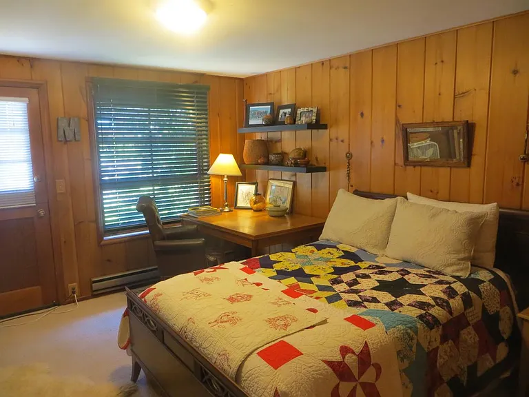 Bedroom with study zone, and dutch door leading to back pati