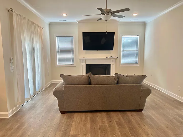 70" 4K television mounted in family room stays with the home. Couch and chairs are optional. No Pets allowed in the home.