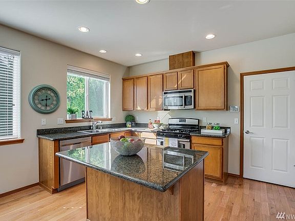 kitchen features all stainless steel appliances, a gas range and granite counter tops.
