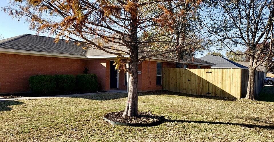 located on a spacious corner lot with large mature trees