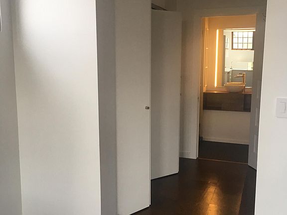 View of closet and bath beyond.