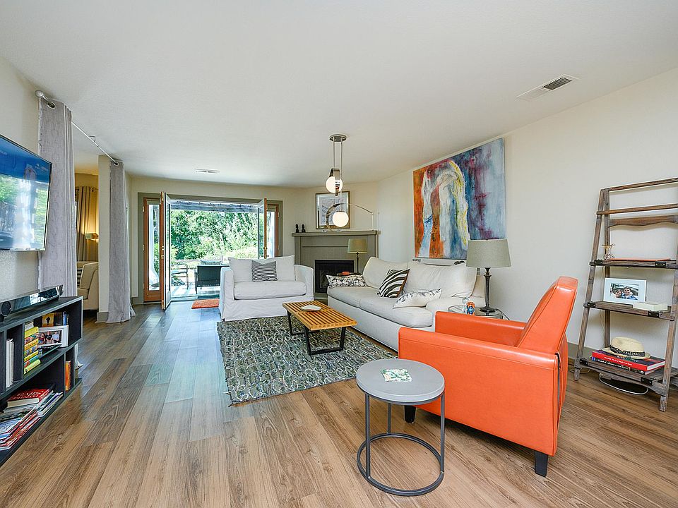 View of the living area from the kitchen, with expansive French doors opening onto the gorgeous patio.