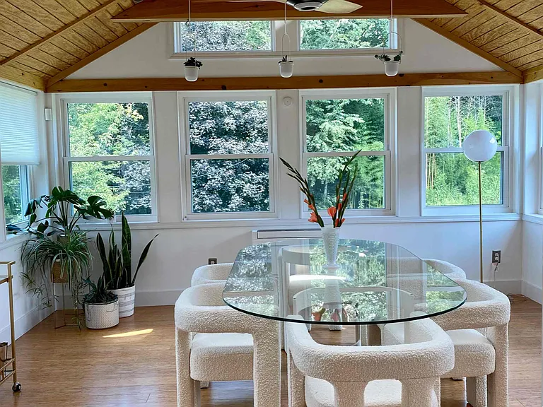 4 seasons room with seating for 6 and views of the backyard