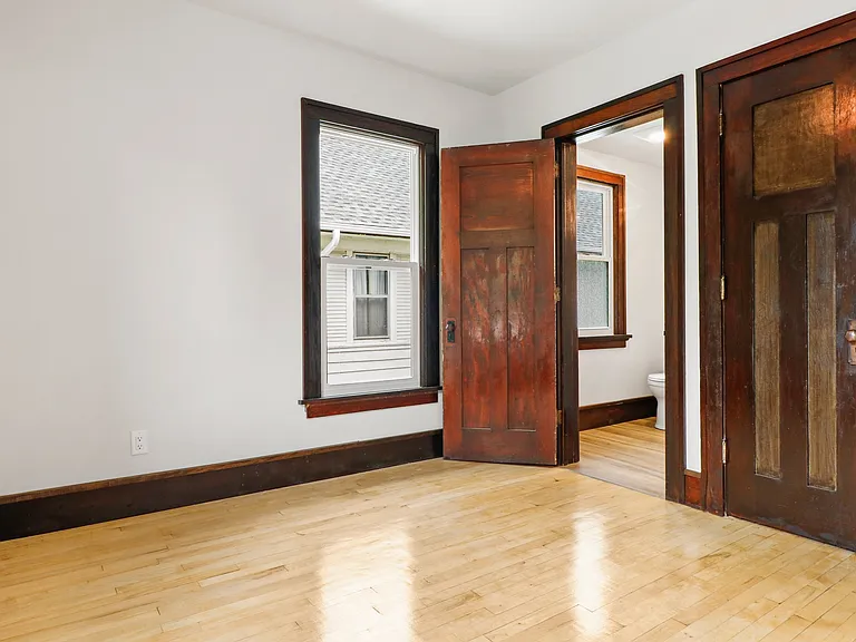 A shot of the back bedroom looking into bathroom. SHINING FLOORS NOTED!