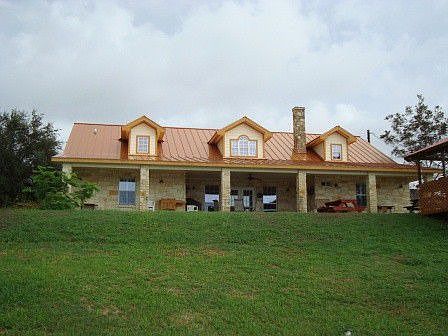Hill Country Flair with Limestone, Metal Roof, Fireplace and Decorative Dormers in Attic