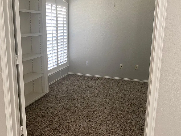 Office with built-ins and a closet.