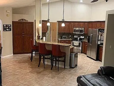 open concept XL eat in kitchen with large breakfast bar. Granite and steel