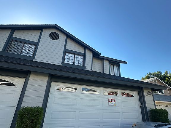 Front of home, garage door is operable by a garage clicker and a mounted garage door button inside of the garage.