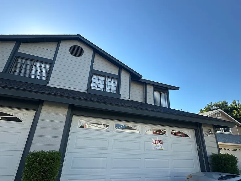 Front of home, garage door is operable by a garage clicker and a mounted garage door button inside of the garage.
