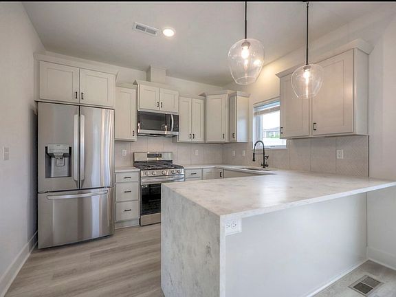 soft close cabinets and quartz counter top and modern kitchen with smart appliances