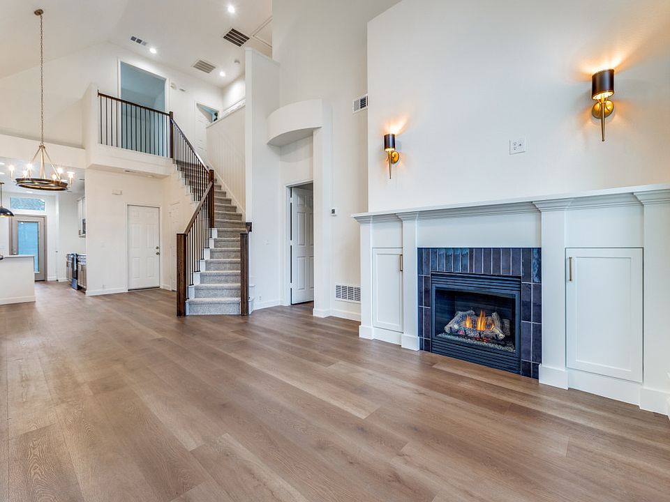 Living room with gas fireplace and beautiful new stair case. All new flooring and lighting. 16 x 16 ft