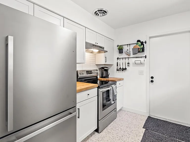 Laundry located right out this door in the kitchen