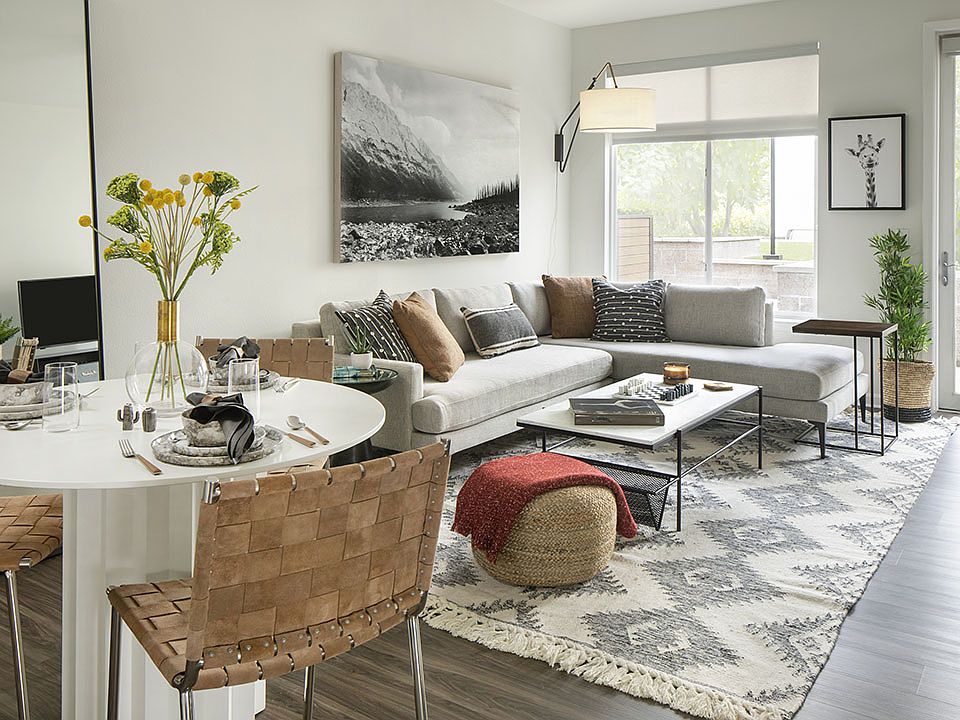 Apartment dining and living room with wood-style flooring.