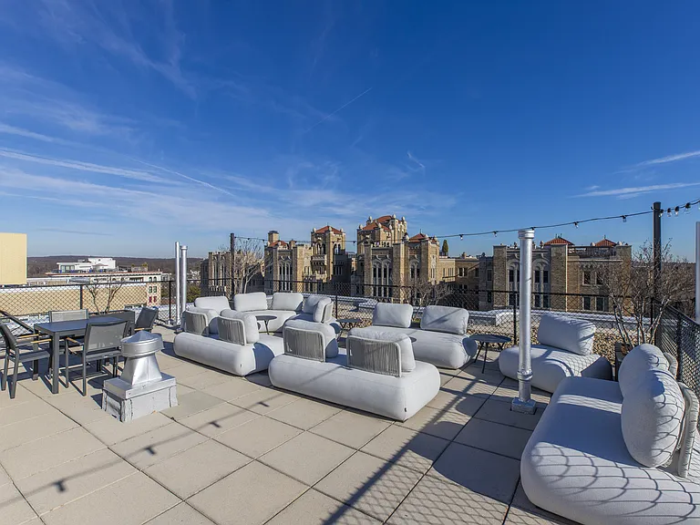 A rooftop deck with a DC skyline view