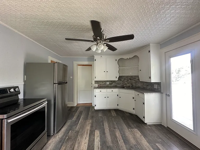 Full kitchen with range, refrigerator, and pantry space