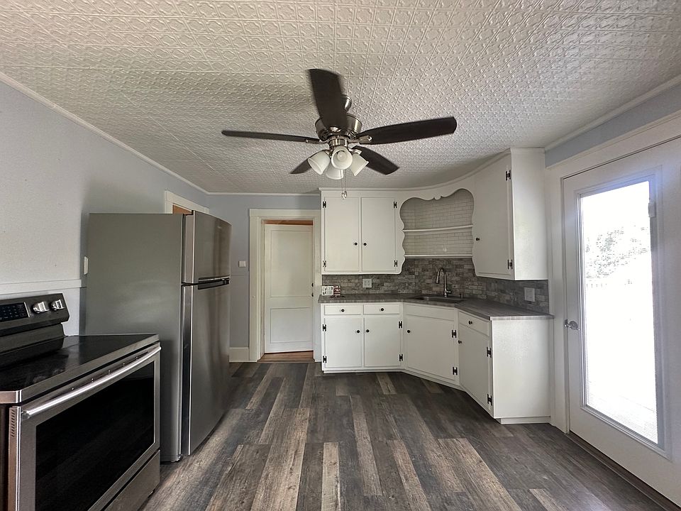 Full kitchen with range, refrigerator, and pantry space
