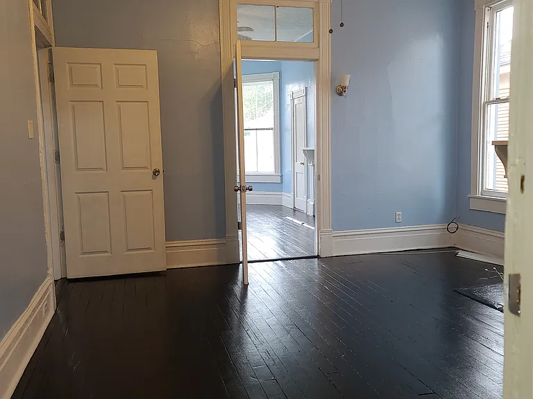 Middle room with door to hallway on Left and door in middle to front room