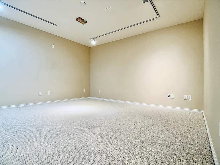 Versatile bonus room, previously designed as a soundproofed theater, featuring a ceiling mount for a projector_ideal for media, work, or creative use.