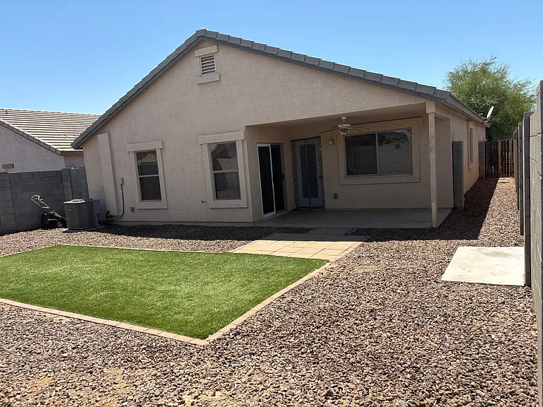 Backyard with fake turf grass.