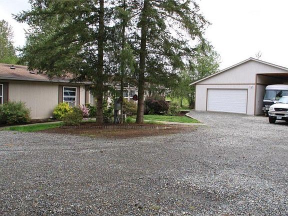 The garage/shop easily holds 3 cars and has covered RV parking.