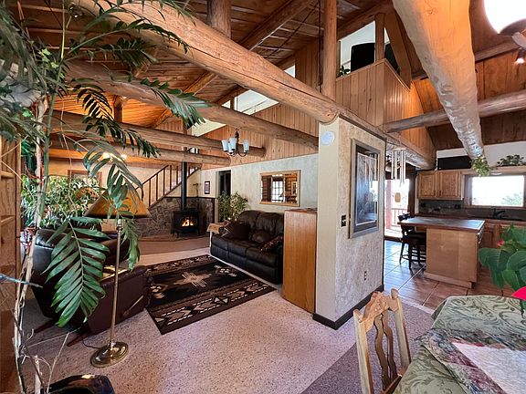 Living Room from Dining room with gas stove. Stairs lead to large lofted family room.