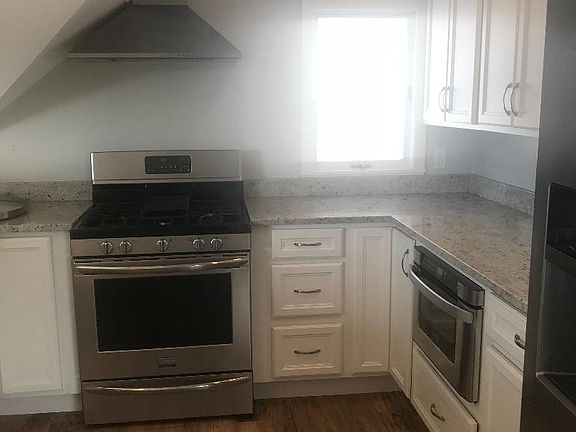 Kitchen open to living and dining, slider and deck