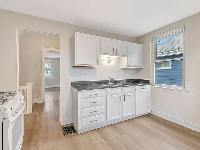 The updated kitchen has granite, dishwasher, garbage disposal, and gas oven.