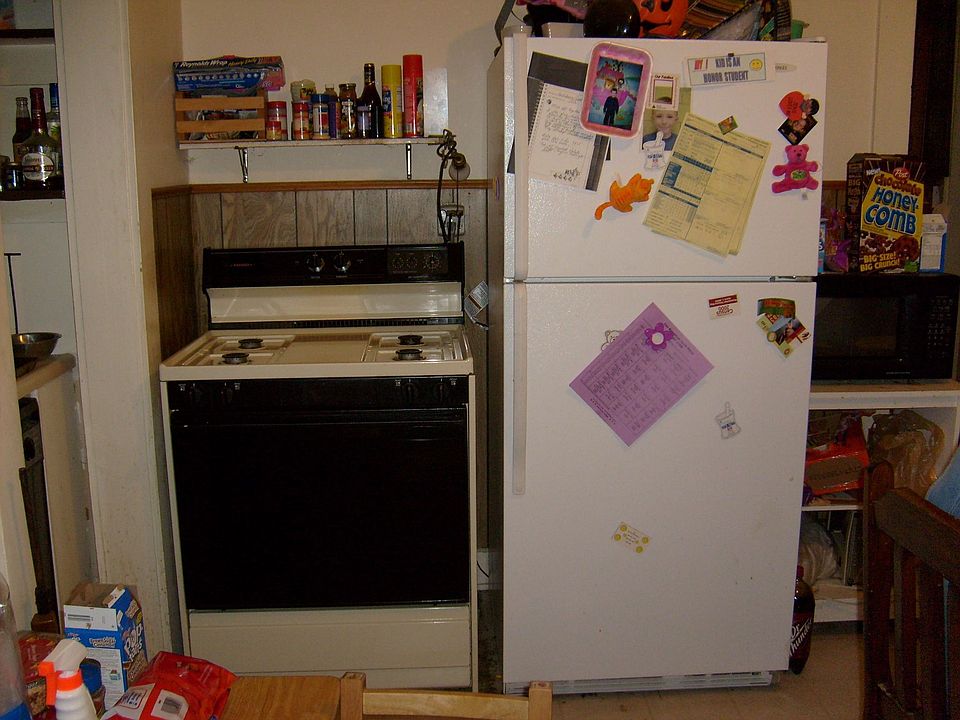 Kitchen with range, refrigerator 