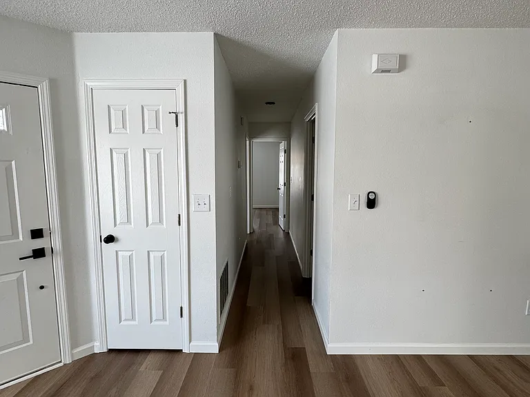 Central hallway connecting secondary bedrooms and bathroom.