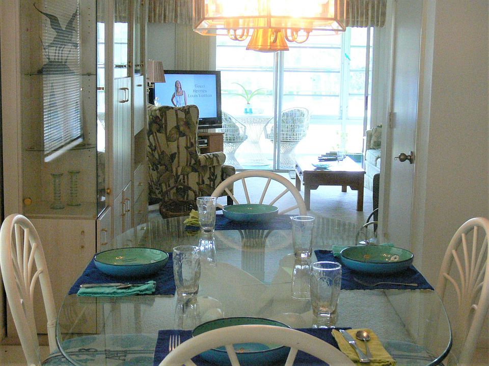 View from kitchen thru the lanai to the water and 9th hole.