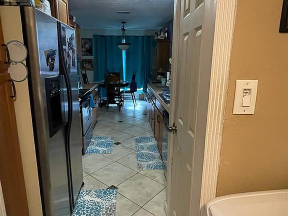 From laundry room, looking into kitchen. Refrigerator stays.