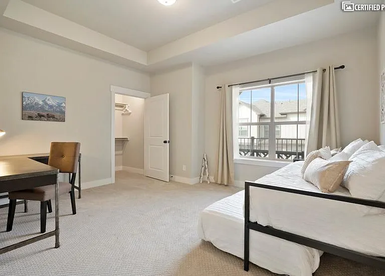 Large secondary bedroom functions as an office or bedroom