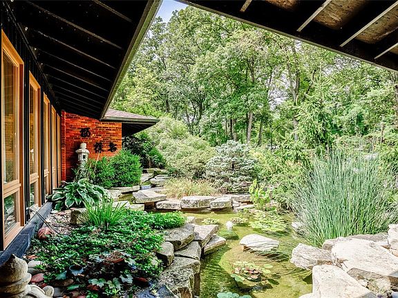 Water fall and pond, as viewed from the covered front porch when entering home.