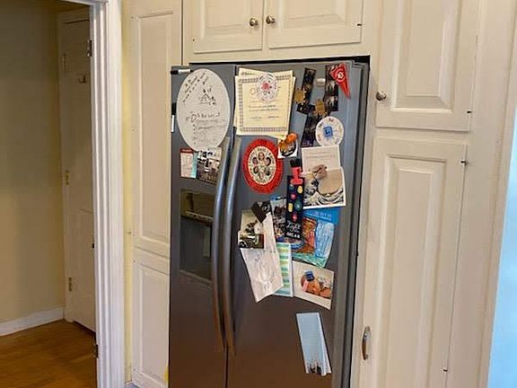 Stainless Steel refrigerator with custom cabinets