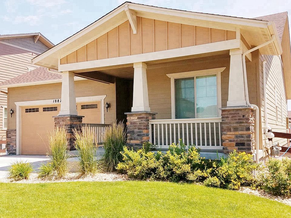 Front of the Ranch house with fully landscaped lawn
