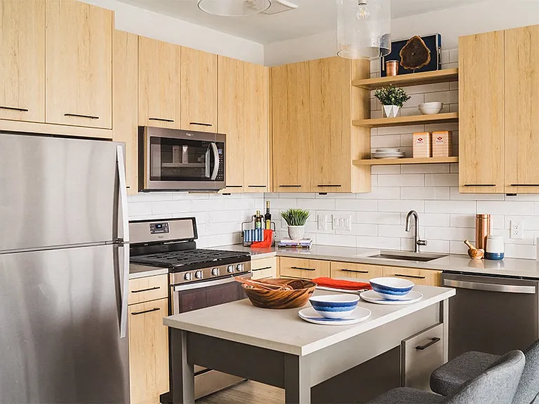 Stainless steel Whirlpool appliances including gas range and hidden-control dishwashers