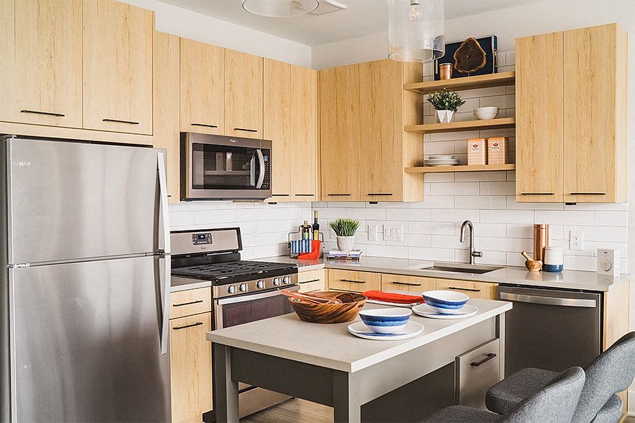 Stainless steel Whirlpool appliances including gas range and hidden-control dishwashers