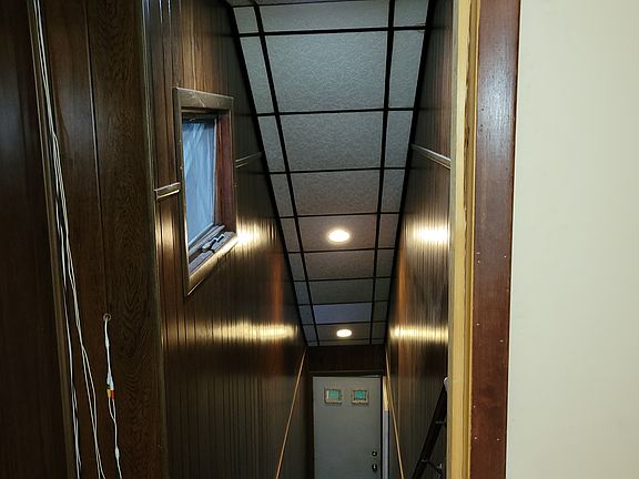 Downward view of staircase and lower entry door.