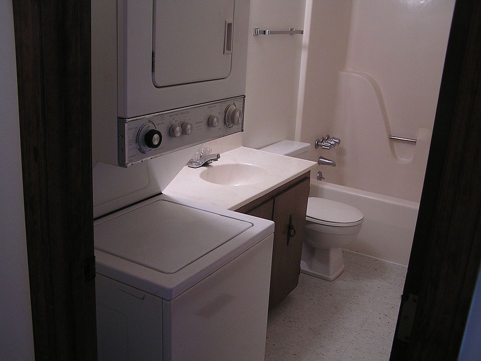 bath with stacked washer and dryer
