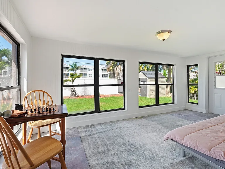Florida room with full size futon bed and gaming table (option to include 50 inch TV as well).