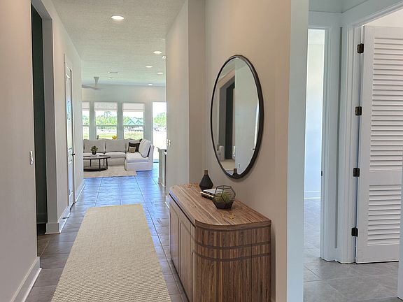 Virtually staged. Enter to find 10' ceilings, level 5 smooth wall finishes, tall baseboards, and contemporary tile throughout.
