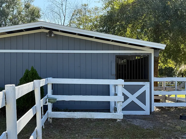 2nd barn has 3 stalls. one opens up to a second. This opens to two separate paddocks. Barn was painted inside and out as well as bars. The little Dutch door is new.