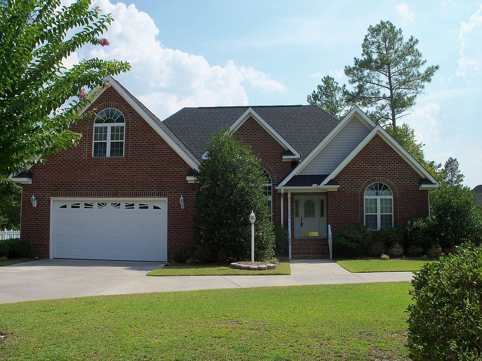 All brick home with two entrance drive