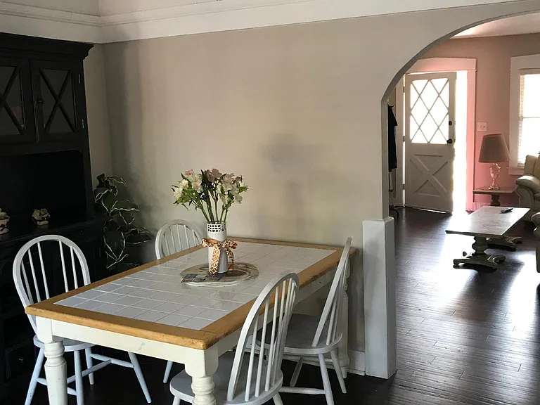 Dining room leading to living room with arch doorway.
