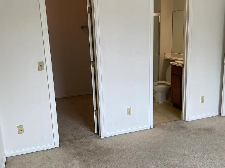 Upstairs master bedroom with 3/4 bath on right and walk in closet on left