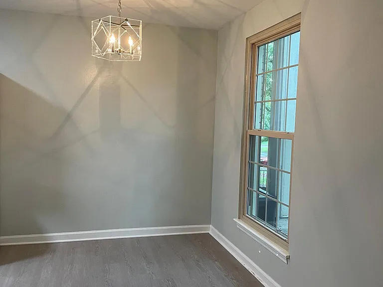 Dining area with contemporary chandelier.