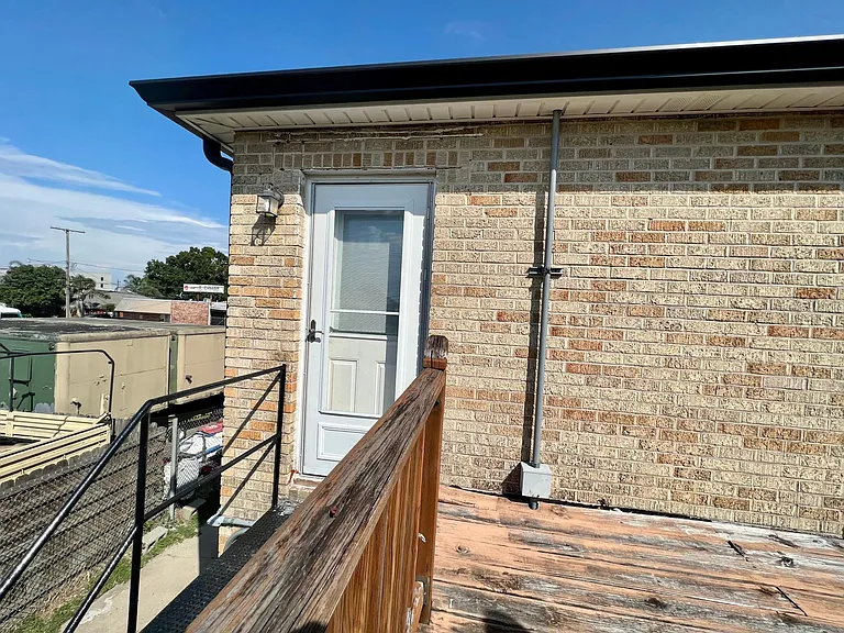 Rear access with Storm door and outside lighting