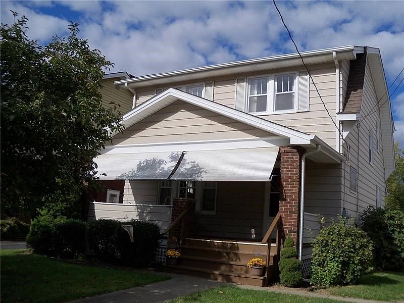 Front view  with Large  Relaxing Carpeted Front Porch and   roll up awnings