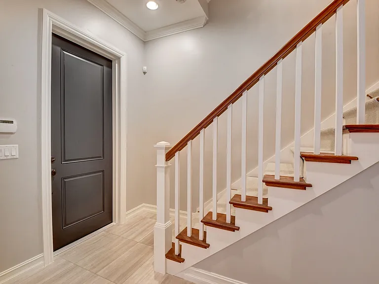 View of front door entrance to 2nd floor steps
