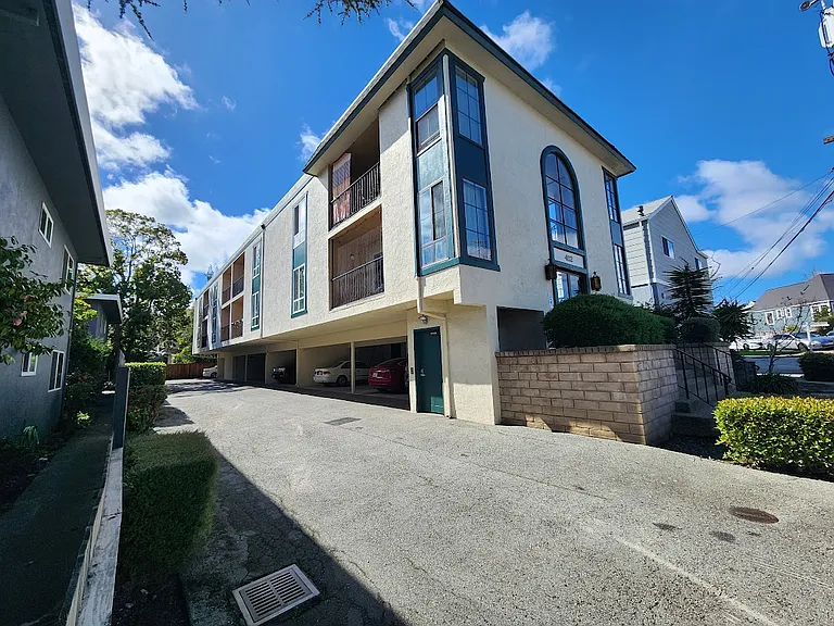 Side of building and view of carports